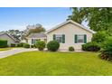 Well-manicured lawn and landscaping enhance the curb appeal of this lovely single-story home at 1202 Formby Ct., Myrtle Beach, SC 29588