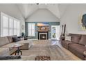 Bright living room featuring a fireplace, vaulted ceilings, and access to the backyard at 133 Hartwell Dr., Little River, SC 29566