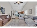 Bright living room with a vaulted ceiling, tile floors, and comfortable seating at 133 Hartwell Dr., Little River, SC 29566