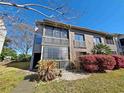 Corner condo unit featuring brick and gray siding, along with dual screened-in patios on two levels at 1356 Glenns Bay Rd. # 201B, Surfside Beach, SC 29575