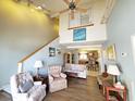 Bright living room with high ceilings, a ceiling fan, and a seamless view into the kitchen at 1356 Glenns Bay Rd. # 201B, Surfside Beach, SC 29575