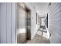 Hallway view of condo building with elevator and white trim at 142 Birch N Coppice Dr. # 5, Surfside Beach, SC 29575