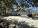 View of house with attached garage, large driveway and landscaped front yard offering ample parking and curb appeal at 1599 Hawthorn Dr., Pawleys Island, SC 29585