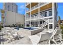 A luxurious pool and hot tub area surrounded by comfortable lounge chairs at 1605 Ocean Blvd. S, North Myrtle Beach, SC 29582