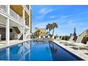 Stunning pool area showcasing the clear blue water and surrounding palm trees at 1605 Ocean Blvd. S, North Myrtle Beach, SC 29582