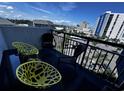 Relaxing balcony with stylish chairs and a vibrant cityscape backdrop at 2001 S Ocean Blvd. # 621, Myrtle Beach, SC 29577