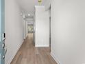 Bright hallway with beautiful wood-look flooring and neutral paint at 2024 Copper Creek Loop, Longs, SC 29568