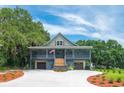 Lovely exterior view of this two-story home with a garage, large driveway, landscaping and American flag at 224 Oak Bay Dr., Georgetown, SC 29440