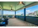 Inviting outdoor porch area with serene views, ceiling fans, rocking chairs and comfortable seating at 224 Oak Bay Dr., Georgetown, SC 29440