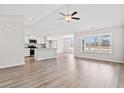 Bright, open-concept living space with wood floors, recessed lighting and lots of light from a bank of windows at 235 Six Mile Creek Dr., Georgetown, SC 29440