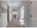 Bright hallway with hardwood floors and neutral paint provides a welcoming transition into the main living areas at 3020 River Island Way, Myrtle Beach, SC 29588