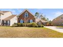 Brick home with black shutters surrounded by lush greenery, offering curb appeal at 3108 Byrom Rd., Myrtle Beach, SC 29579