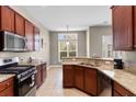 Well-equipped kitchen with granite countertops, stainless steel appliances, and wooden cabinets at 3108 Byrom Rd., Myrtle Beach, SC 29579