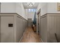 Hallway with hardwood floors, wainscotting, and high ceilings, creating an inviting and elegant entrance at 338 Hillwood Ct., Longs, SC 29568