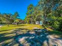 Expansive, well-manicured lawn offering a serene, park-like setting and ample space at 3641 Half Pint Rd., Longs, SC 29568