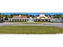 Exterior shot of the community clubhouse with a well-manicured lawn and circular driveway at 390 Starlit Way, Myrtle Beach, SC 29579