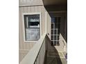 View of a balcony with wood flooring, a window with curtains, and a glass-paneled door at 4242 Pinehurst Circle # N4, Little River, SC 29566