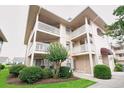 This multi-story condo features multiple balconies, well-maintained landscaping, and a covered entryway at 4242 Pinehurst Circle # N4, Little River, SC 29566