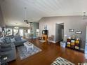 Spacious living room featuring vaulted ceiling, hardwood floors, and a comfortable seating area at 471 Deerfield Links Dr., Surfside Beach, SC 29575