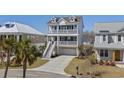 Beautiful three-story beach house with balconies, well-kept lawn, and convenient ground-level garage at 482 Harbour View Dr., Myrtle Beach, SC 29579