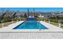 A modern backyard swimming pool features a unique water feature and manicured landscaping at 482 Harbour View Dr., Myrtle Beach, SC 29579