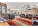 Cozy living room with a bar area, comfortable leather chairs, and a large ceiling fan at 4916 Darby Ln., Myrtle Beach, SC 29579