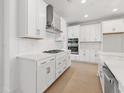 Modern kitchen with white cabinetry, stainless steel appliances, and quartz countertops at 516 Ayrhill Loop, Myrtle Beach, SC 29588