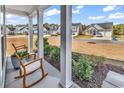 Inviting front porch with rocking chairs and lush landscaping, providing a relaxing outdoor space at 5606 Whitebark Dr., Myrtle Beach, SC 29577