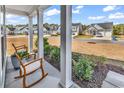 Inviting front porch features rocking chairs and a pleasant view of the neighborhood street at 5606 Whitebark Dr., Myrtle Beach, SC 29577