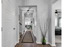 Bright hallway with wood floors leading to bedroom, living area, and staircase at 5606 Whitebark Dr., Myrtle Beach, SC 29577