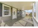 Inviting front porch features neutral colors, a decorative front door, and plenty of space to relax and unwind at 606 Britt St., Georgetown, SC 29440