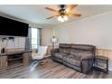 Comfortable living room featuring a ceiling fan, plank flooring, and a plush brown couch at 606 Britt St., Georgetown, SC 29440