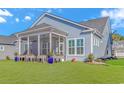 Inviting screened-in back porch with outdoor seating, perfect for relaxing and entertaining at 6366 Chadderton Circle, Myrtle Beach, SC 29579