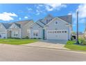 Attractive home with a two-car garage, manicured lawn, and charming curb appeal in a suburban neighborhood at 6366 Chadderton Circle, Myrtle Beach, SC 29579