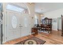 Welcoming entryway featuring ornate front doors, hardwood floors and formal dining area at 650 Buck Trail, Longs, SC 29568