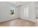 Dining room featuring hardwood floors, white walls and a stylish chandelier at 738 Macon Alley, Myrtle Beach, SC 29588