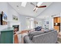 Inviting living room with a fireplace, vaulted ceiling, and French doors leading to the backyard at 75 Prestwick Dr., Pawleys Island, SC 29585