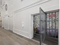 A cozy dog room under the stairs features paneled walls and a secure, decorative metal gate at 780 Johnson Ave., Myrtle Beach, SC 29577