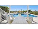 Inviting outdoor space with a swimming pool, lounge chairs, and a dining area for entertaining guests at 937 Ocean Blvd. S, North Myrtle Beach, SC 29582