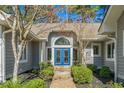 Inviting entryway with a blue double front door, brick path, and manicured landscaping at 1240 Pine Valley Rd., North Myrtle Beach, SC 29582