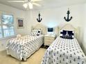 Bright bedroom featuring nautical themed decor and comfortable twin beds at 145 S Dunes Dr. # 109, Pawleys Island, SC 29585