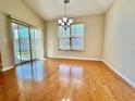 Spacious dining area featuring wood floors, natural light, and modern chandelier at 1612 Fairforest Ct., Conway, SC 29526