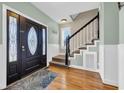 Elegant entryway with hardwood floors, a decorative door, and staircase at 1631 27Th Ave. N, North Myrtle Beach, SC 29582