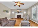 Cozy living room featuring hardwood floors, a fireplace, and large windows at 1631 27Th Ave. N, North Myrtle Beach, SC 29582