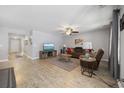 Cozy living room with wood-look floors, ceiling fan, and comfortable seating at 168 Oak Leaf Dr., Longs, SC 29568