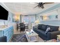 Cozy living room with stylish decor, comfortable seating, and an ocean view from the windows at 2001 S Ocean Blvd. # 1505, Myrtle Beach, SC 29577