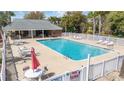 Community pool with lounge chairs, tables, white fence, and a covered area at 2013 Silvercrest Dr. # 30-F, Myrtle Beach, SC 29579