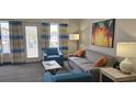 Comfortable living room with a cozy sofa, armchairs, and a balcony with lovely outdoor views at 218 Double Eagle Dr., Surfside Beach, SC 29575