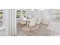 Bright dining area featuring a white table set for six in an elegant space at 2404 Watershed Way, Longs, SC 29568