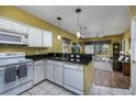 Bright kitchen with white cabinets and black countertops at 244 Sun Colony Blvd. # 102, Longs, SC 29568